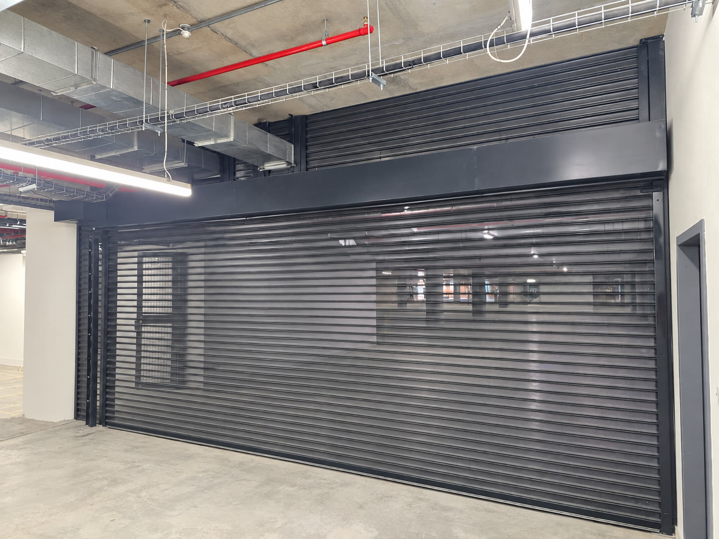 Large commercial roller shutter installation in an underground parking area
