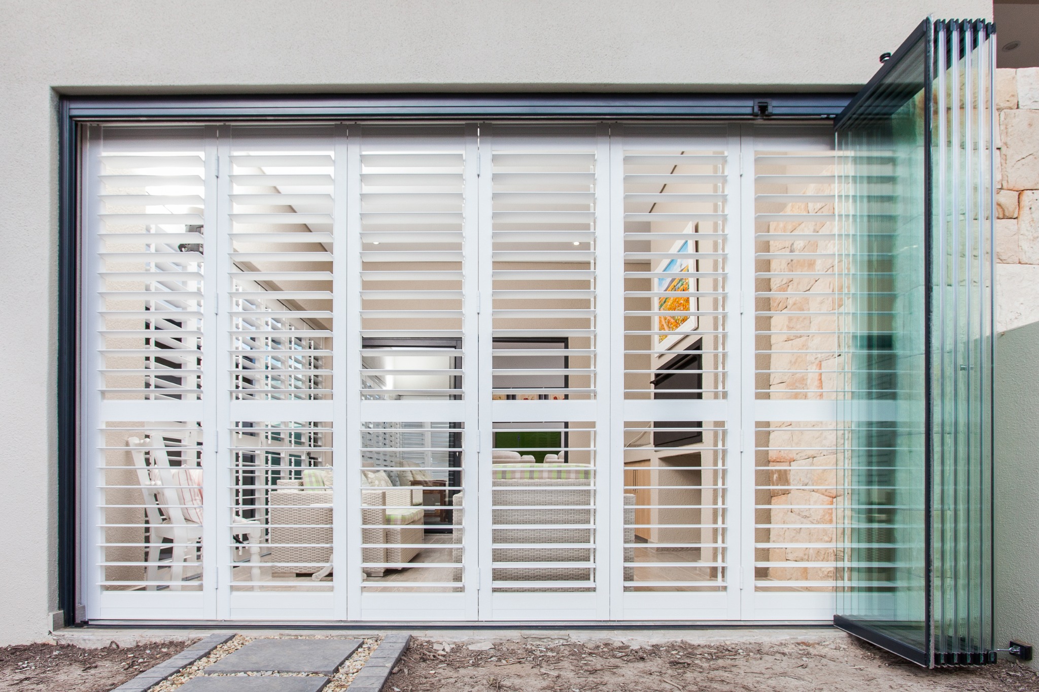 White aluminium louvre security shutters across a residential opening