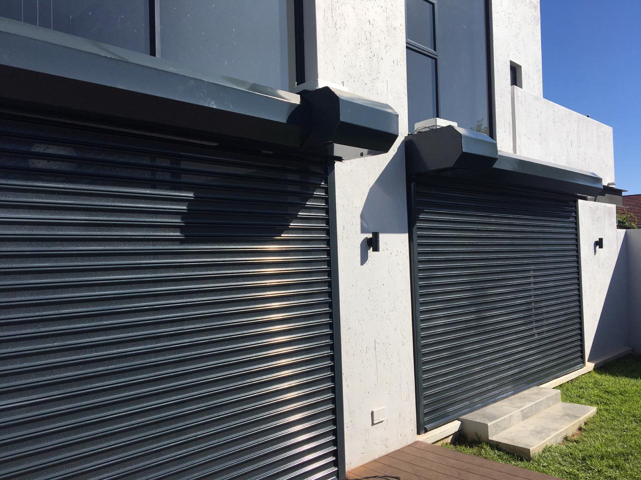 Dark grey residential roller shutters installed by MAXIPROJECTS